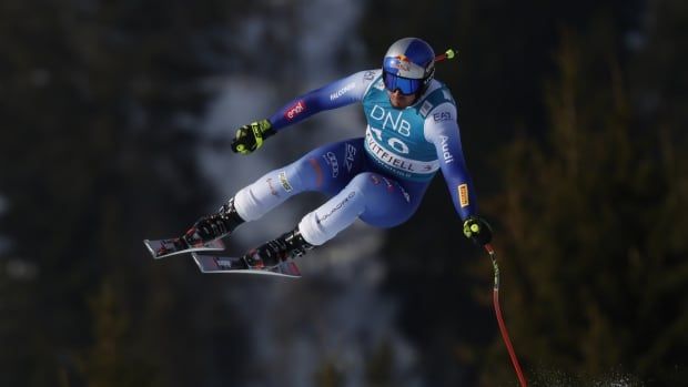 A skier races down the hill.