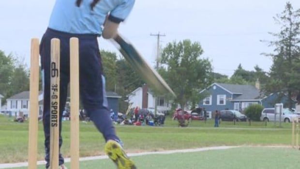 Man playing cricket.