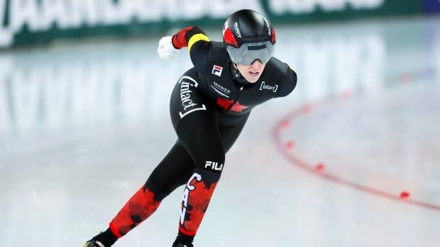 A women's skater competes in a race.