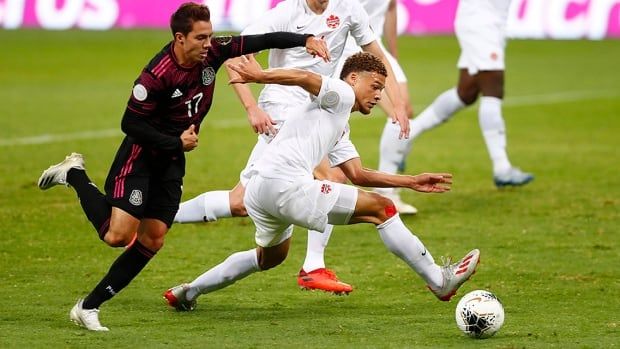 Sebastián Córdova of México fights for the ball with Zorhan Bassong of Canada during a semifinal match as part of the CONCACAF men's Olympic qualifier at Jalisco Stadium on March 28, 2021 in Guadalajara, Mexico.