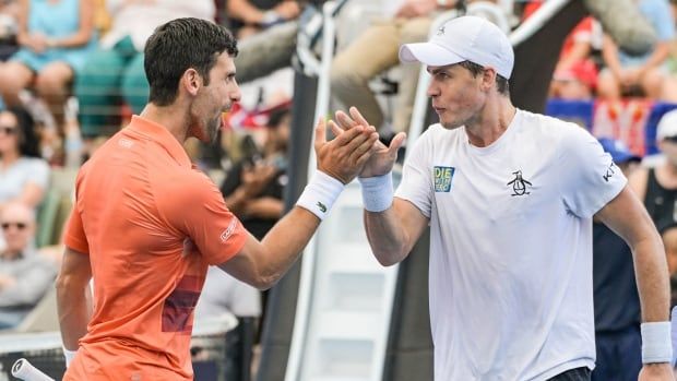 Two tennis players celebrate.