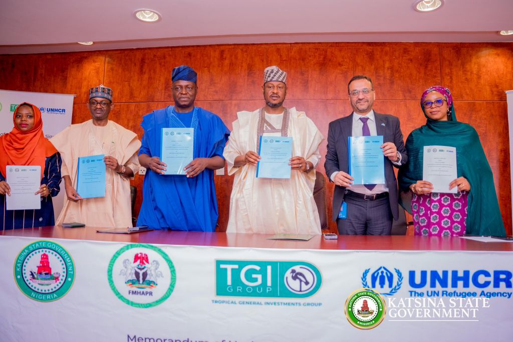 Governor Dikko Radda(4th left), Minister for Humanitarian Affairs and Poverty Reduction, Nentawe Goshwe Yilwatda (3rd left); Farouk Gumel, Vice Chairman of Tropical General Investments (2nd left); Arjun Jain, UNHCR Representative in Nigeria (2nd right) and others during the official signing of a Memorandum of Understanding (MoU) at the Katsina State Government House.