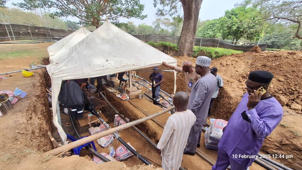 The ongoing restoration work on the vandalised underground transmission line near Millennium Park, Abuja