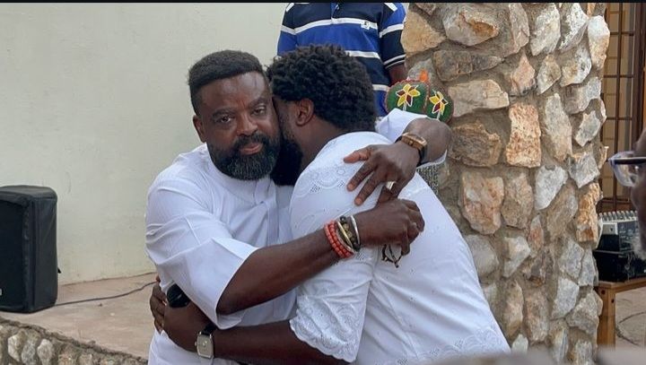 Kunle and Aremu Afolayan hugging each other at their mother's wake keep